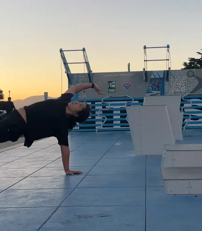 Selena Seto in an animal flow crab reach with one arm sweeping overhead