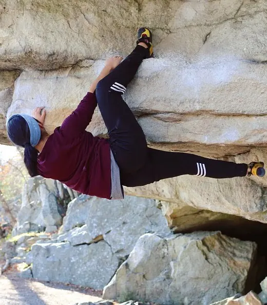 Selena Seto bouldering on a sandstone overhang