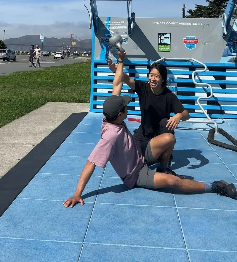 Selena and a client celebrating a kettlebell set with the Golden Gate Bridge in the background